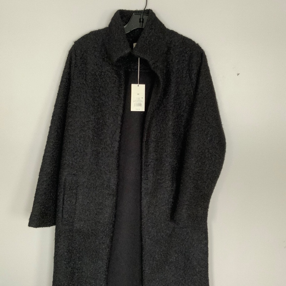 Black boucle coat, lightweight, high neck, pockets but no closure. Car coat look